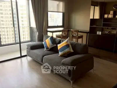 Modern living room with large windows and balcony in high-rise apartment