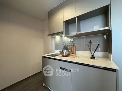 Modern compact kitchen with sleek cabinetry and integrated appliances