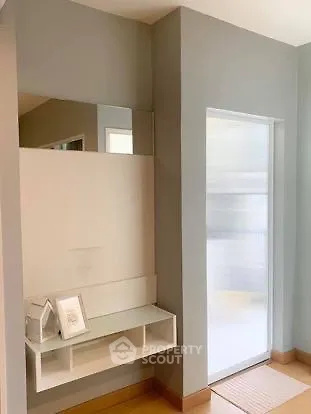 Modern minimalist hallway with sleek mirror and storage unit