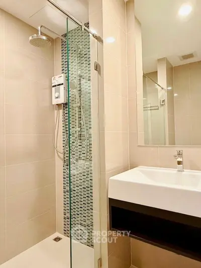 Modern bathroom with glass shower and sleek sink design