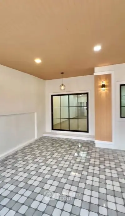 Modern interior with stylish lighting and tiled flooring, perfect for versatile living space.