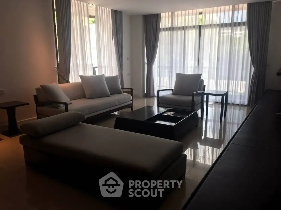 Elegant living room with modern furniture and large windows