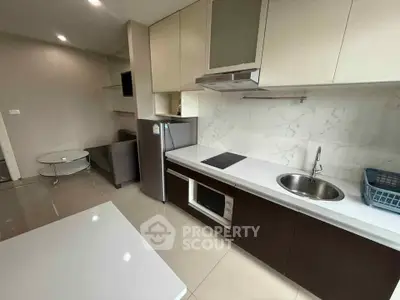 Modern kitchen with sleek cabinetry and integrated appliances in open layout