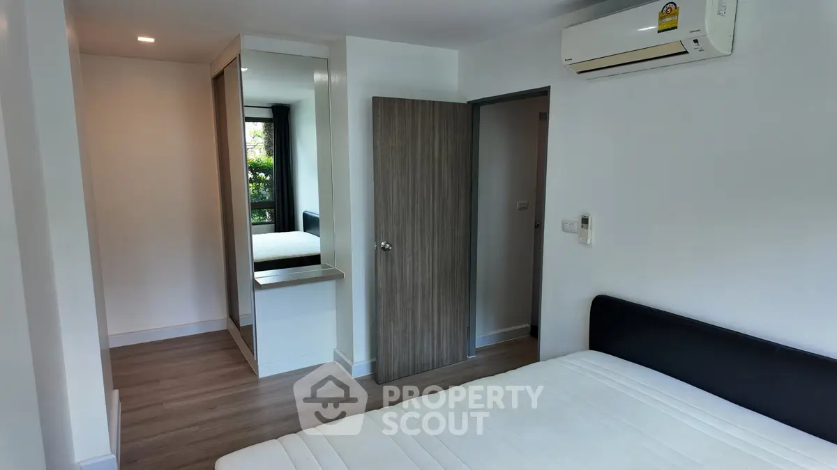 Modern bedroom with sleek design and air conditioning in a stylish apartment.