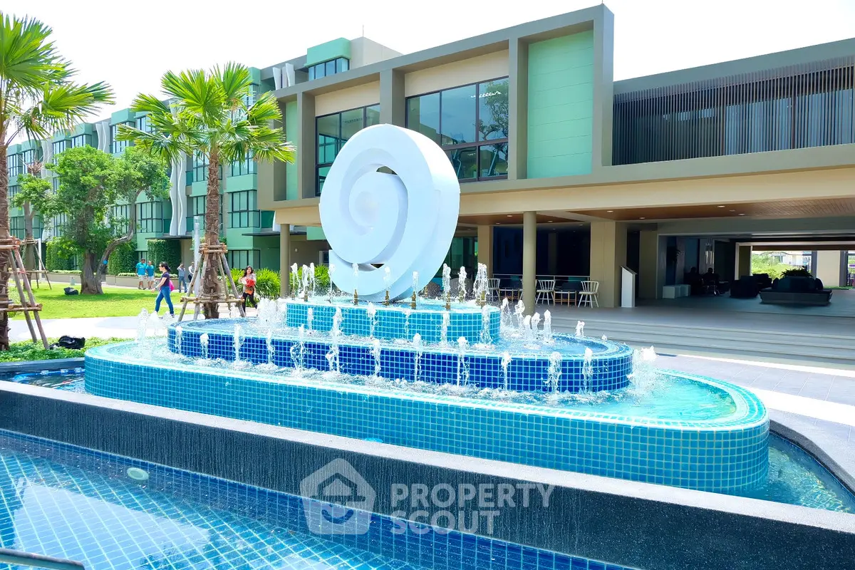 Modern building with unique fountain and lush greenery, perfect for luxury living.