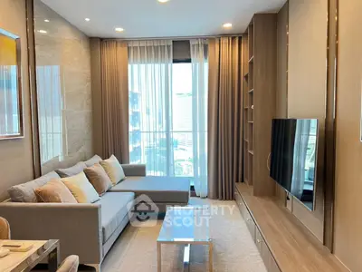 Modern living room with sleek design, large window, and stylish furniture in a high-rise apartment.