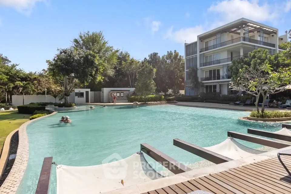 Luxurious residential complex with stunning pool and lush greenery