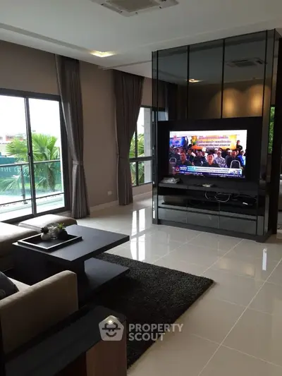 Spacious modern living room with large windows and sleek decor