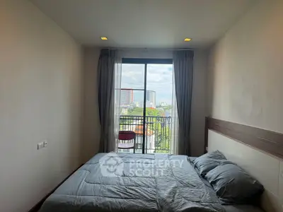 Cozy bedroom with balcony and city view in modern apartment