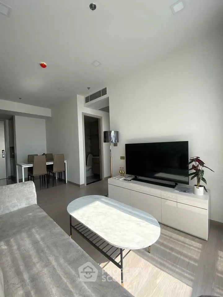 Modern living room with sleek furniture and natural light, perfect for urban living.