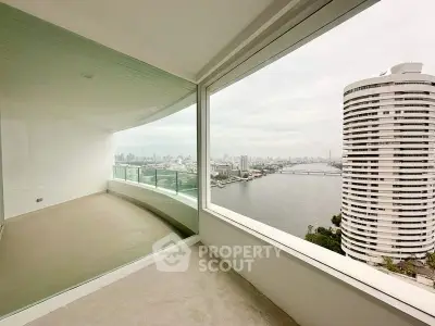Stunning high-rise balcony with panoramic river and city views, perfect for urban living.