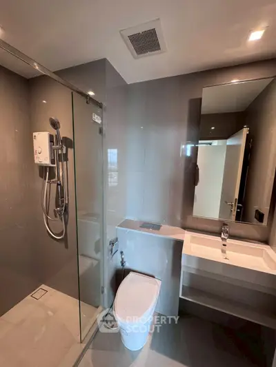 Modern bathroom with glass shower and sleek fixtures