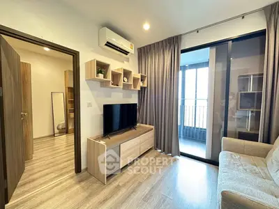 Modern living room with sleek design, featuring a cozy sofa, wall-mounted shelves, and a large window with balcony access.