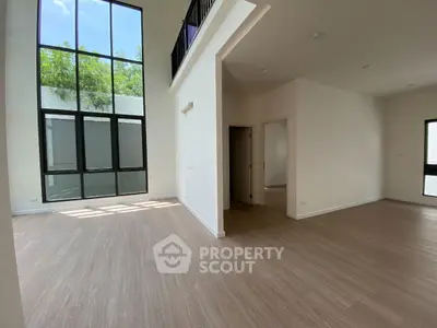 Spacious modern living room with high ceilings and large windows