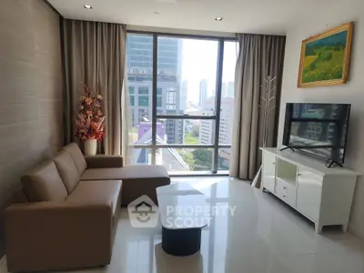 Modern living room with city view, featuring a stylish sofa and flat-screen TV, perfect for urban living.
