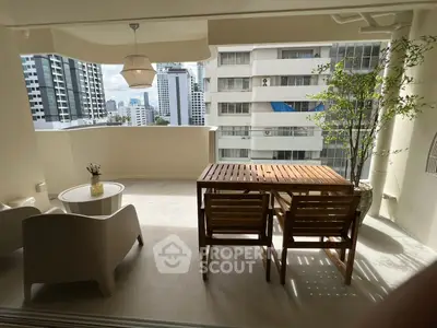 Spacious balcony with modern furniture and city view, perfect for relaxation and entertaining.