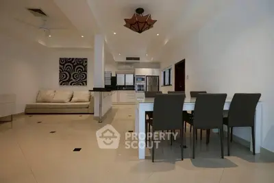Spacious modern living and dining area with elegant furnishings and open layout.