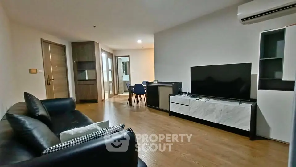 Spacious modern living room with sleek furniture and open dining area