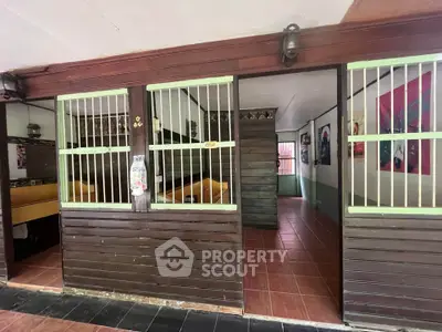 Charming rustic interior with wooden accents and tiled flooring, perfect for cozy living or creative workspace.