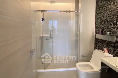 Modern bathroom with glass shower and sleek tile design