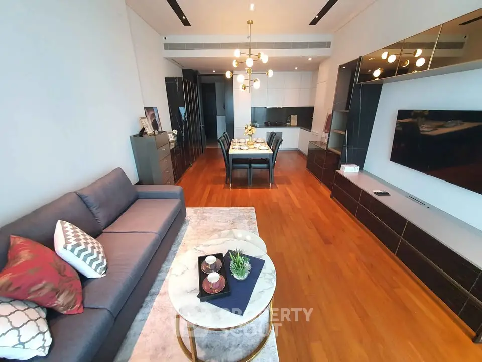 Spacious modern living room with elegant dining area and sleek kitchen design.