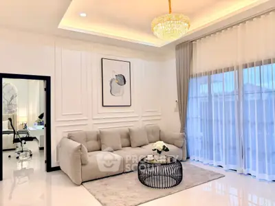 Luxurious living room with elegant chandelier and plush sofa, perfect for modern living.