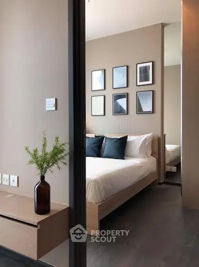 Modern bedroom with stylish decor and cozy ambiance, featuring elegant wall art and plush bedding.