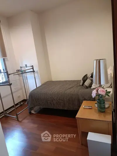 Cozy bedroom with wooden flooring and stylish decor