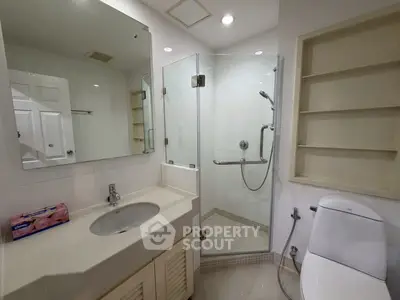 Modern bathroom with glass shower and sleek fixtures in a contemporary home.