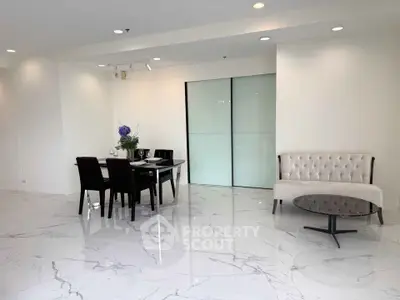 Elegant modern dining area with marble flooring and stylish furniture