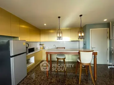 Modern kitchen with stylish lighting, sleek cabinetry, and a spacious island in a contemporary home.