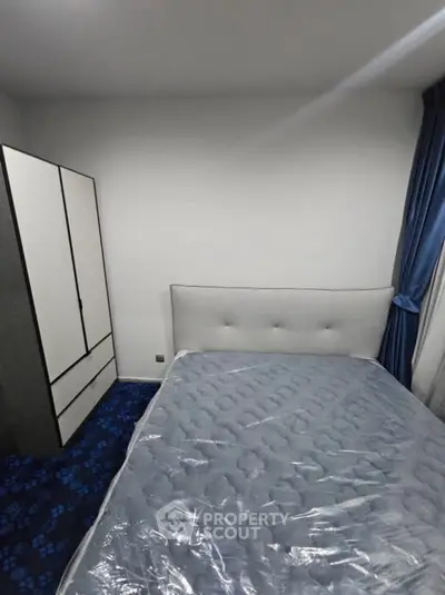 Cozy bedroom with modern wardrobe and plush bed in stylish apartment.