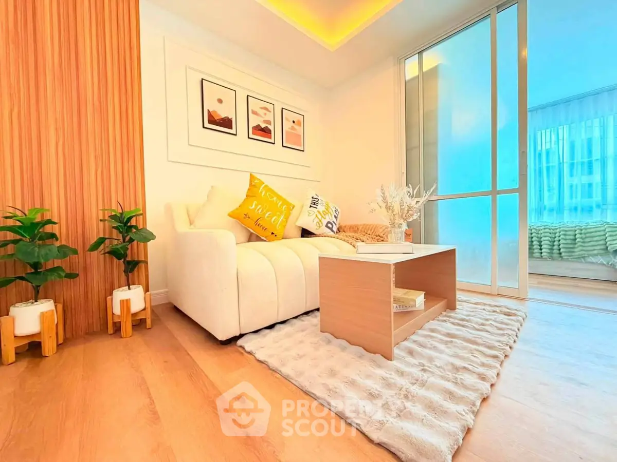 Modern living room with cozy decor and natural light, featuring a plush rug and stylish furniture.
