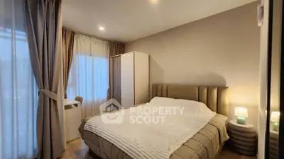 Cozy bedroom with elegant decor and ample natural light, featuring a plush bed and stylish curtains.