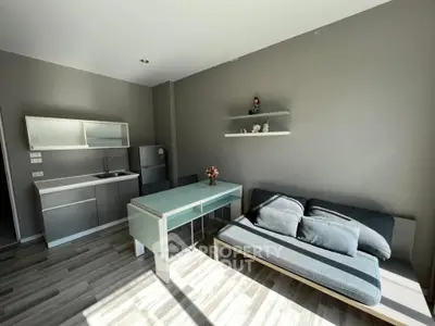 Modern living room with sleek kitchen and stylish decor