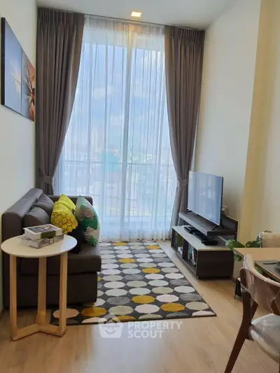 Modern living room with floor-to-ceiling windows and stylish decor in a high-rise apartment.