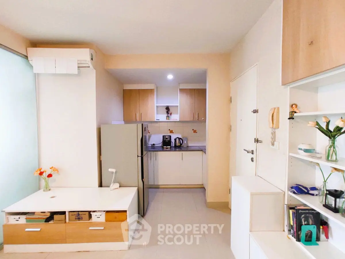 Modern compact kitchen with sleek cabinetry and integrated appliances