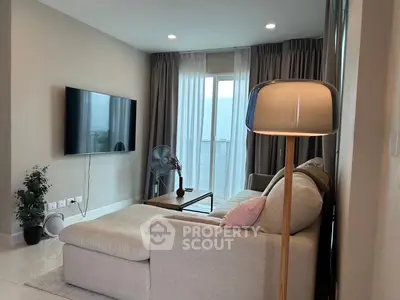 Modern living room with stylish decor, featuring a cozy sofa, wall-mounted TV, and large window with elegant curtains.