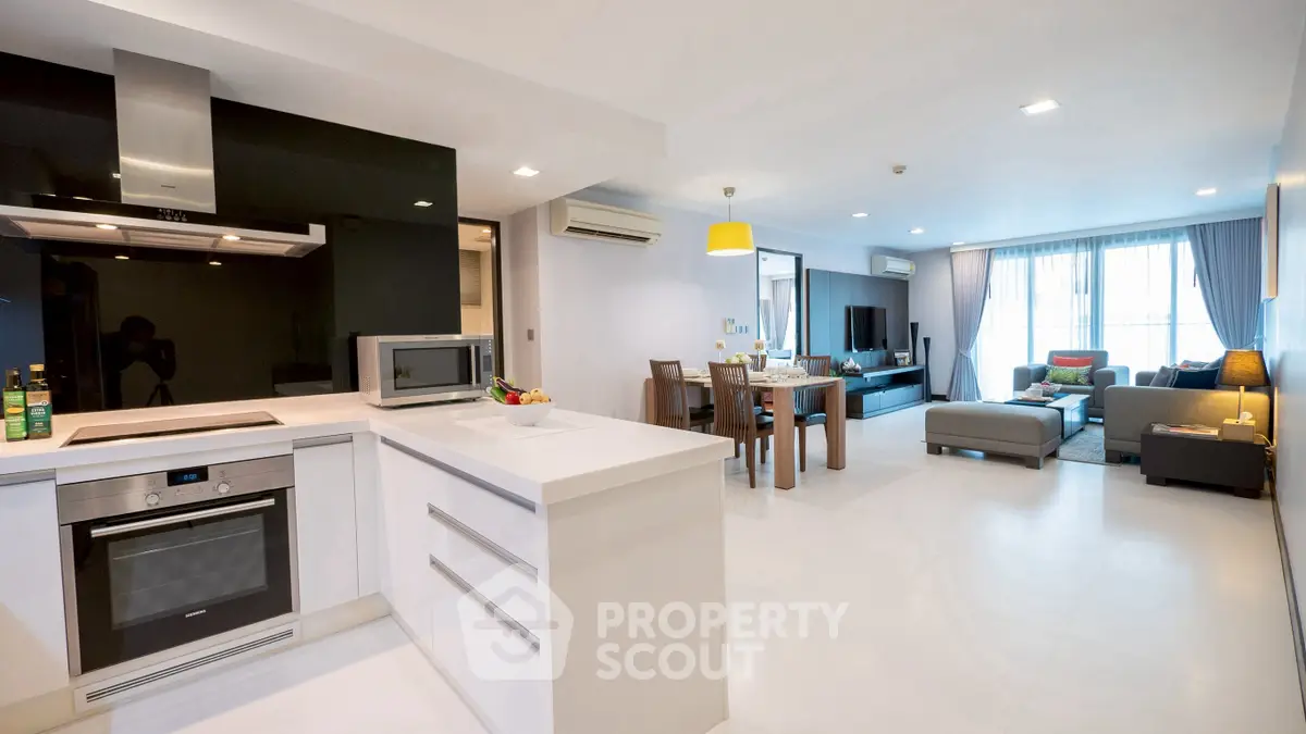 Spacious open-plan living room and kitchen with modern appliances and stylish decor.
