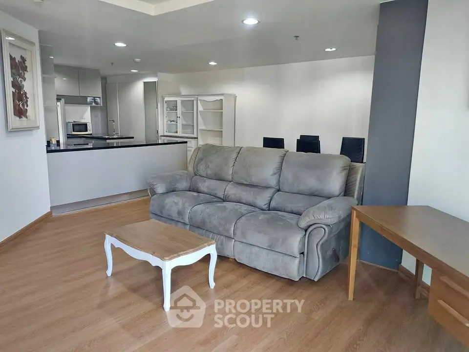 Spacious living room with modern open kitchen and cozy seating area.