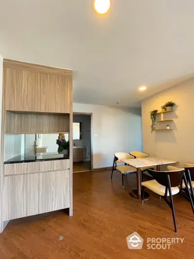 Modern dining area with wooden flooring and stylish furniture