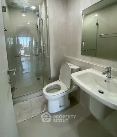 Modern bathroom with glass shower and sleek fixtures