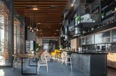 Stunning modern kitchen with open layout and sleek design, featuring high ceilings and stylish lighting.