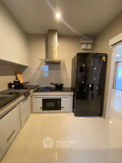 Modern kitchen with sleek black appliances and open layout