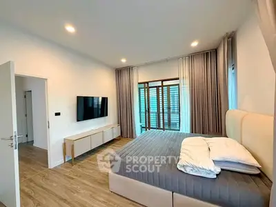 Spacious modern bedroom with large windows and stylish decor