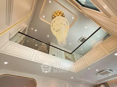 Luxurious high-ceiling living room with grand chandelier and elegant decor