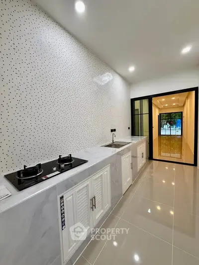 Modern kitchen with sleek design and gas stove in a spacious layout