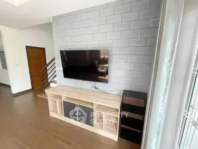 Modern living room with stylish TV unit and sleek wooden flooring
