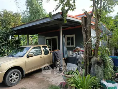 Charming suburban home with carport and lush garden surroundings.