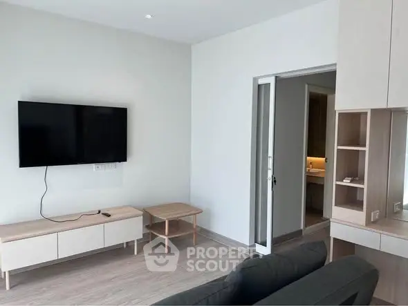 Modern living room with wall-mounted TV and sleek furniture